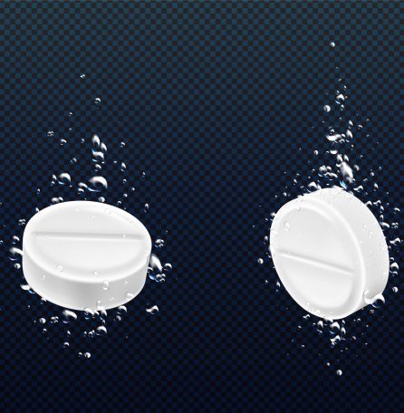 Effervescent pills falling in water. Vector realistic illustration of fizzy round tablets underwater view with bubbles, painkiller medicine dissolving in liquid, soluble medication, disease treatment
